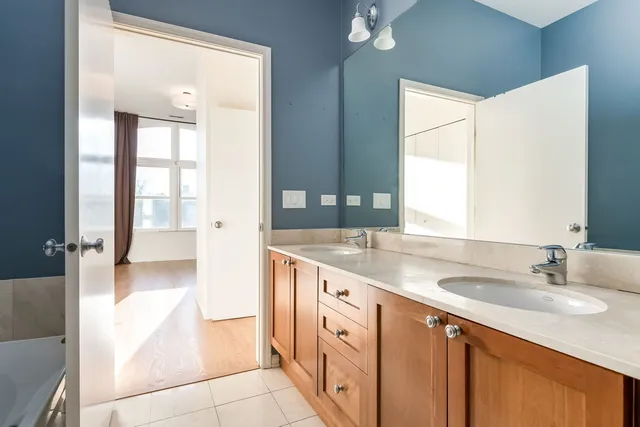 a bathroom with a double vanity sink and a mirror