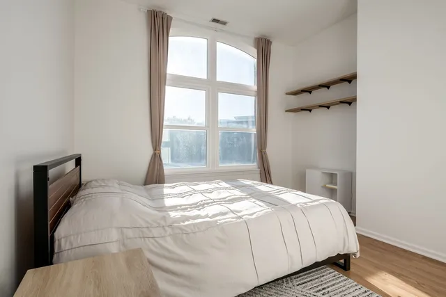 a bedroom with a bed and a window