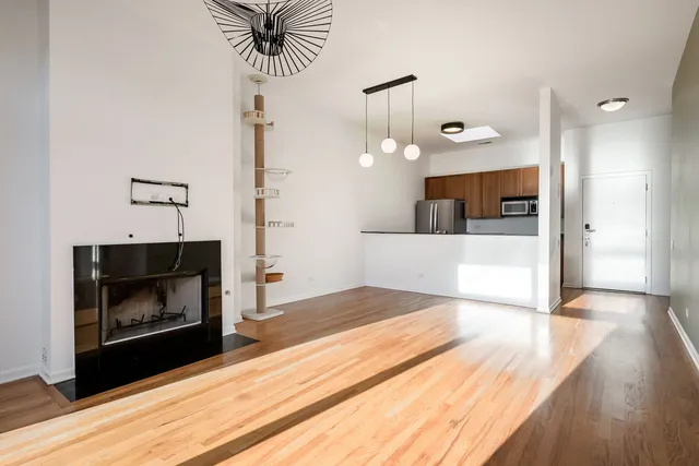 a living room with a fireplace and wooden floor