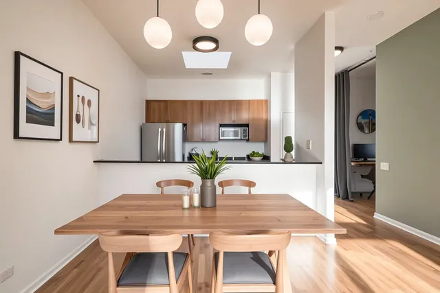 a view of a dining room with furniture and wooden floor