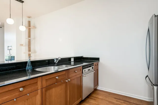 a kitchen with granite countertop a sink and cabinets