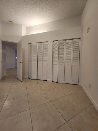 a view of an empty room with closet area