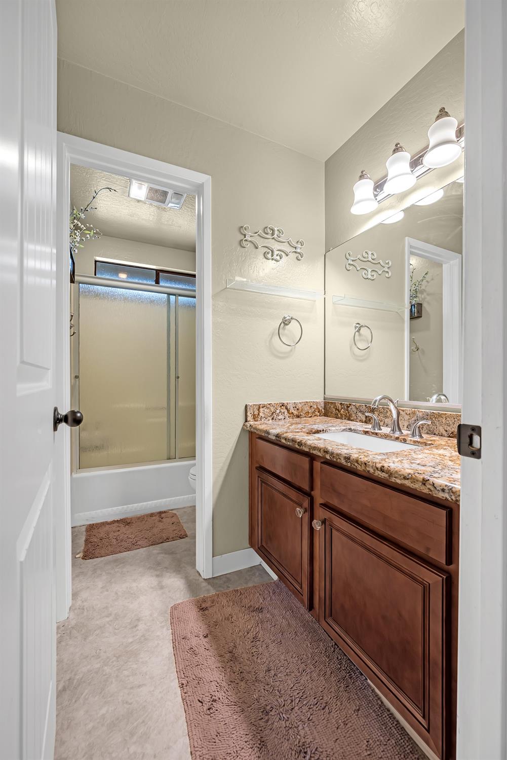 2505 Muir Court Cool, CA 95614 - Photo 15 of 56 a spacious bathroom with a granite countertop sink mirror and a bath tub