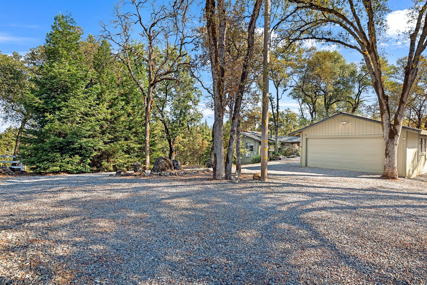 2505 Muir Court Cool, CA 95614 - Photo 27 of 56 a wooden house with trees in front of it