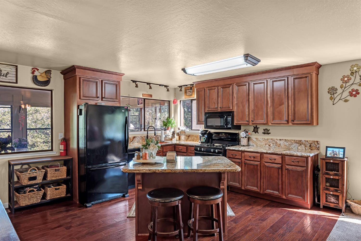 2505 Muir Court Cool, CA 95614 - Photo 3 of 56 a kitchen with a refrigerator a stove a sink dishwasher and microwave with wooden floor