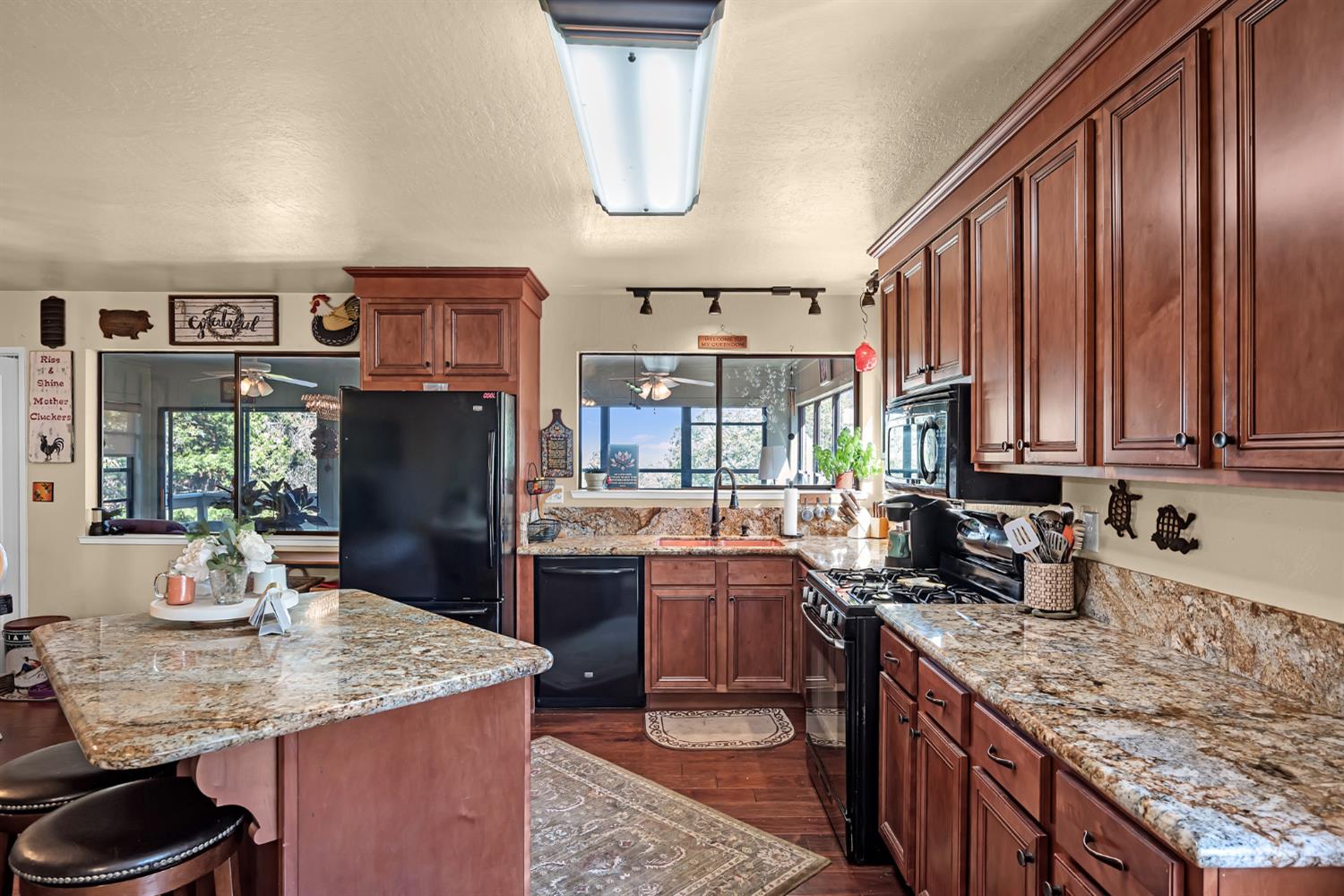 2505 Muir Court Cool, CA 95614 - Photo 4 of 56 a kitchen with stainless steel appliances granite countertop a sink refrigerator stove and microwave