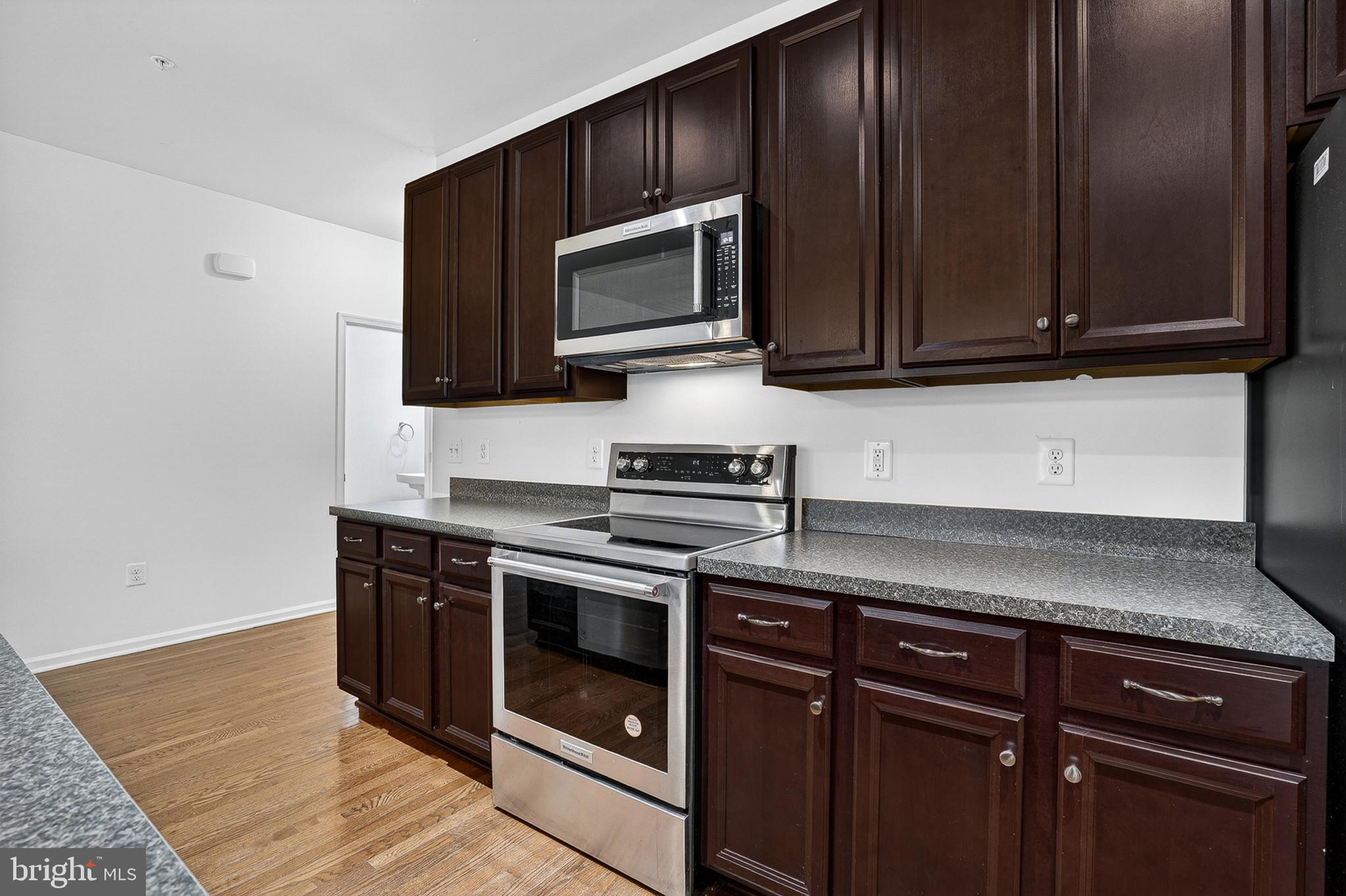 1925 Washburn Court Frederick, MD 21702 - Photo 11 of 41 a kitchen with wooden cabinets and a stove top oven