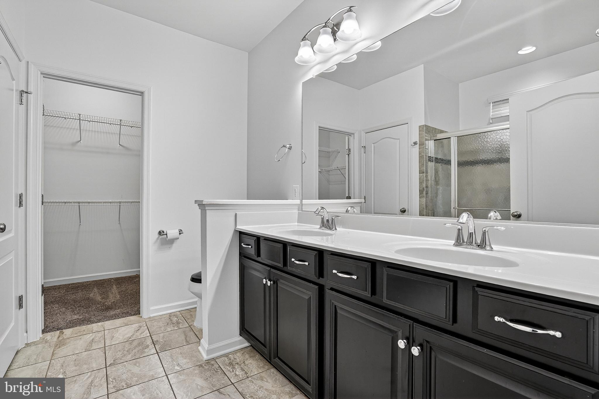 1925 Washburn Court Frederick, MD 21702 - Photo 19 of 41 a bathroom with a double vanity sink a mirror and a shower