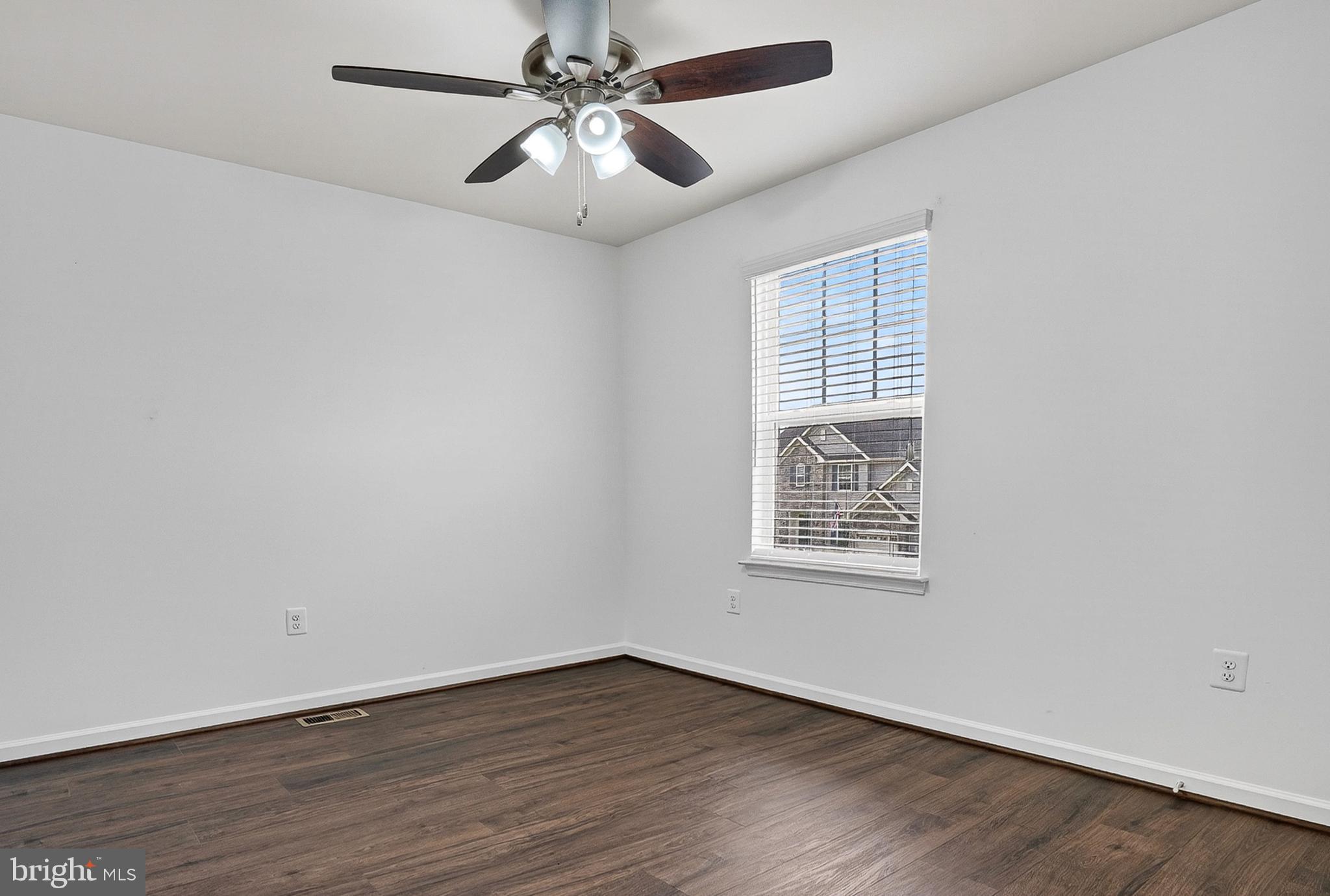 1925 Washburn Court Frederick, MD 21702 - Photo 23 of 41 an empty room with wooden floor fan and windows