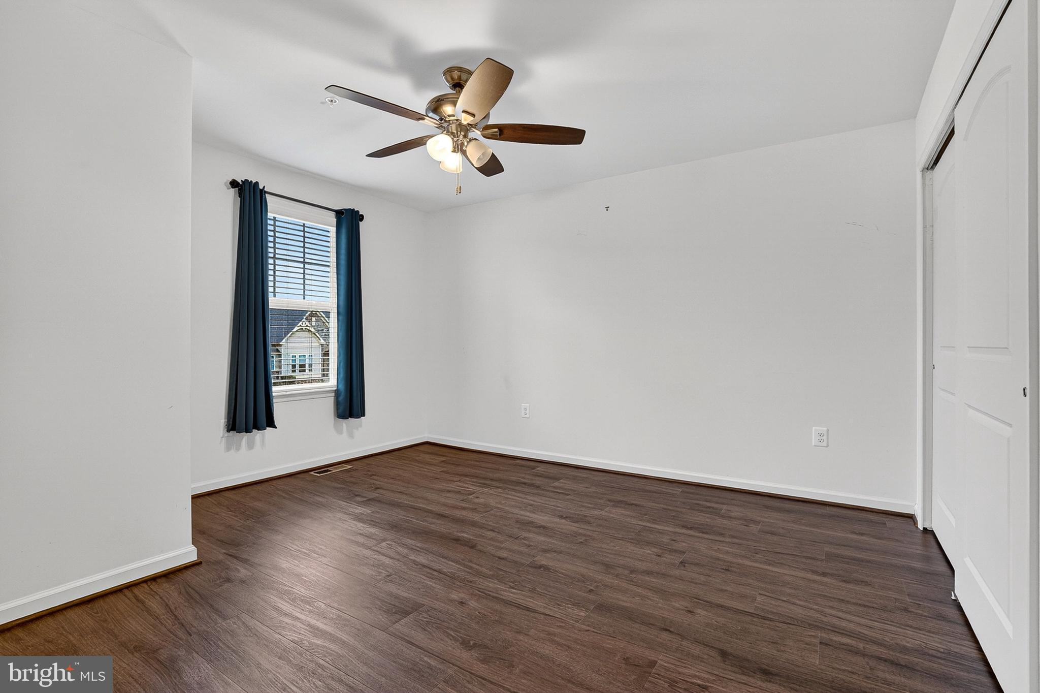 1925 Washburn Court Frederick, MD 21702 - Photo 25 of 41 an empty room with wooden floor chandelier fan and windows