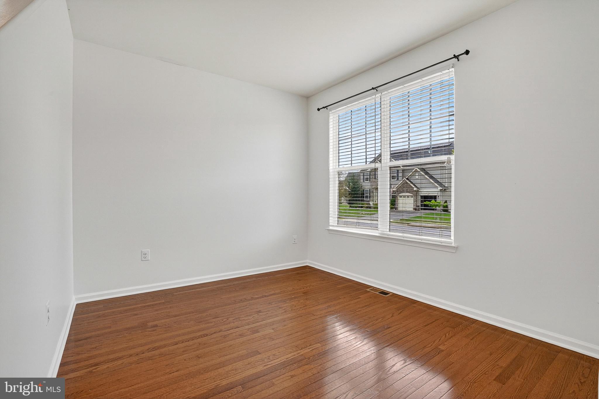 1925 Washburn Court Frederick, MD 21702 - Photo 6 of 41 a view of an empty room with wooden floor and a window