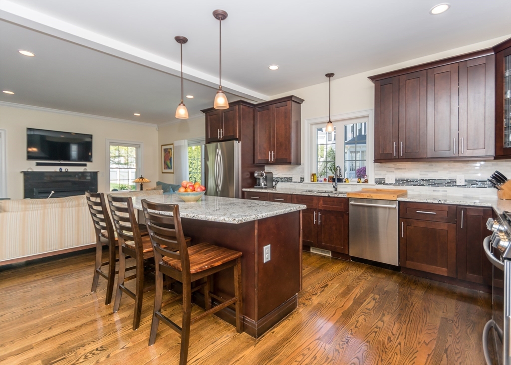 128 Church Street, Unit 2 Waltham, MA 02452 - Photo 14 of 41 a kitchen with a table chairs microwave and cabinets