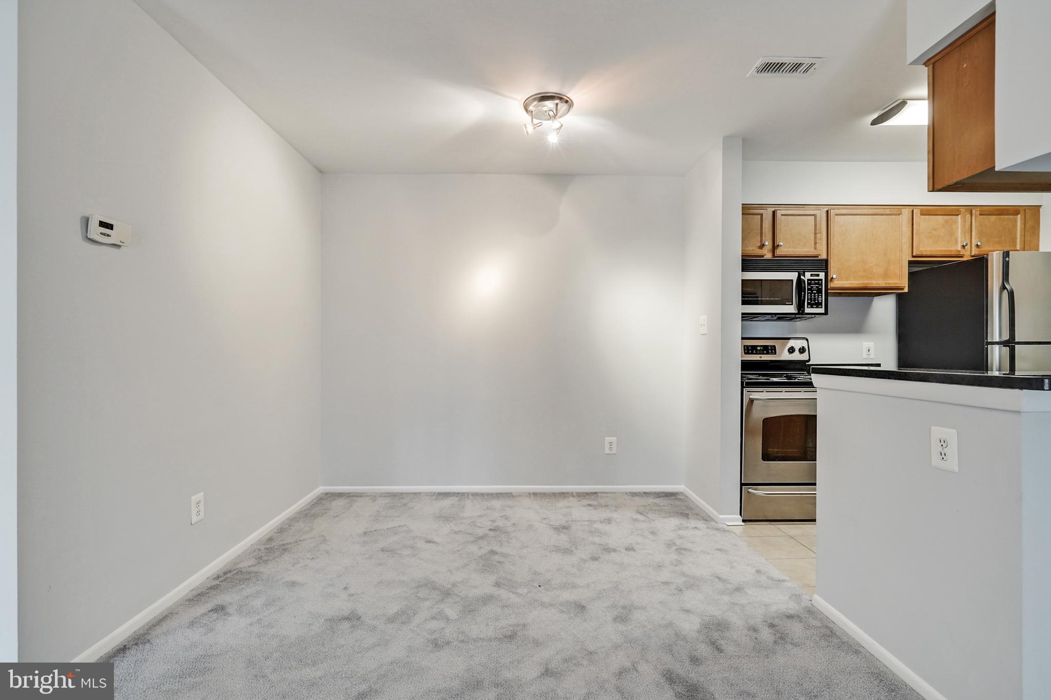1781 Jonathan Way, Unit 1781I Reston, VA 20190 - Photo 7 of 48 an empty room with kitchen view and a window