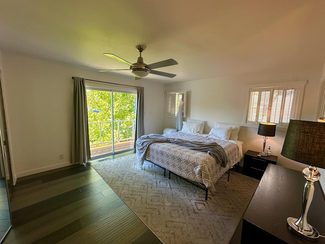 466 Thomson Lane Copperopolis, CA 95228 - Photo 15 of 47 a spacious bedroom with a bed a window and a chandelier