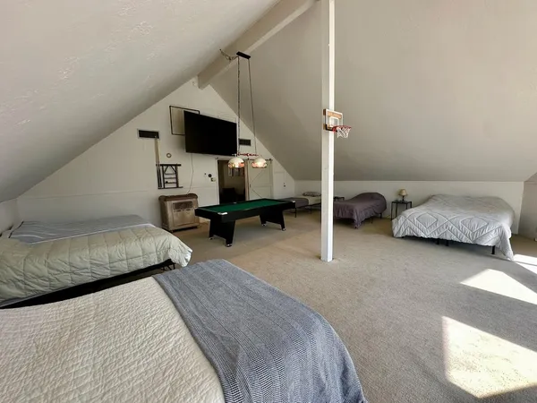 a bedroom with a bed couch and a window