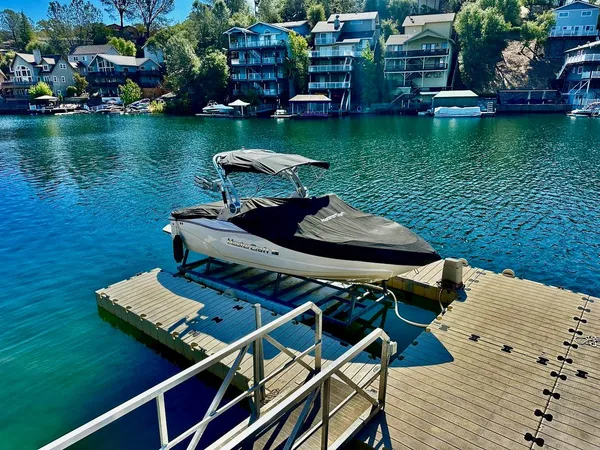 a view of a swimming pool with lawn chairs and a table