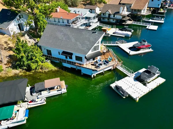 an aerial view of a house with swimming pool garden and outdoor seating