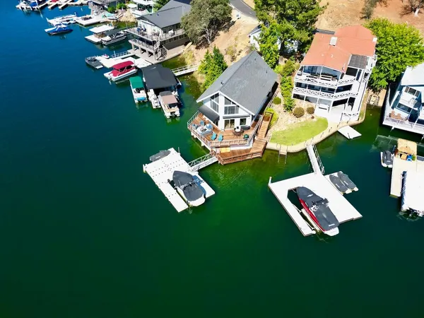 an aerial view of residential house with outdoor space swimming pool and trees