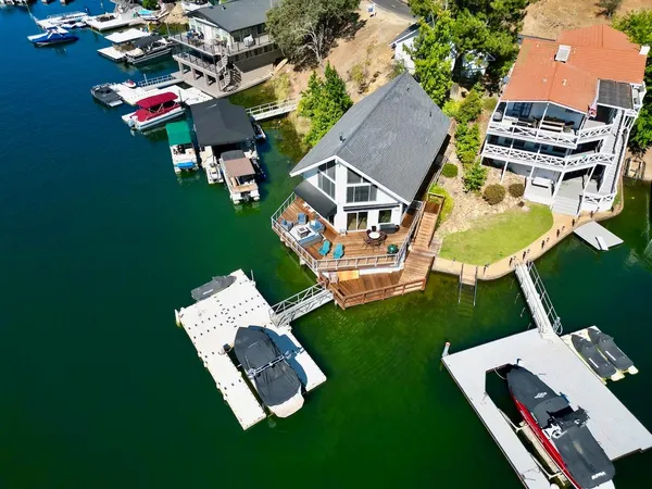 an aerial view of a house with swimming pool garden and outdoor seating