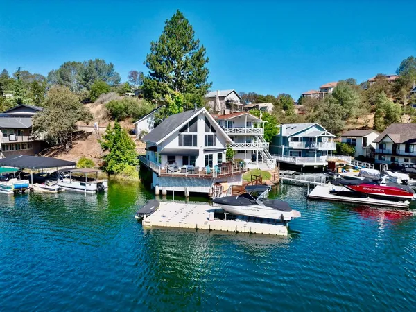 an aerial view of a house with swimming pool garden and patio