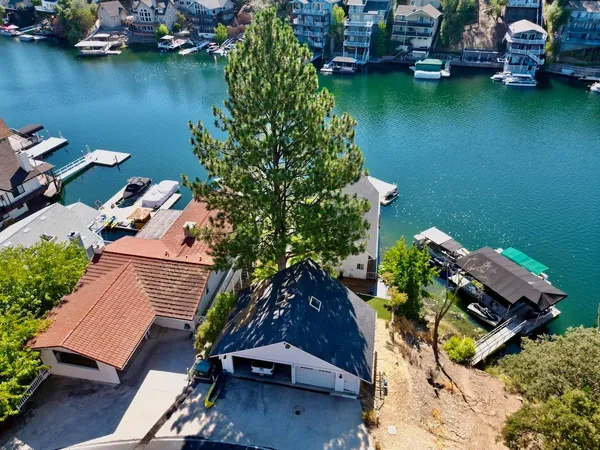 an aerial view of a house with outdoor space and a lake view