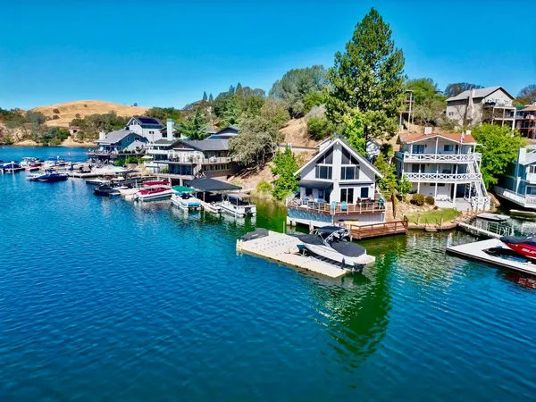 a view of a house with pool and chairs