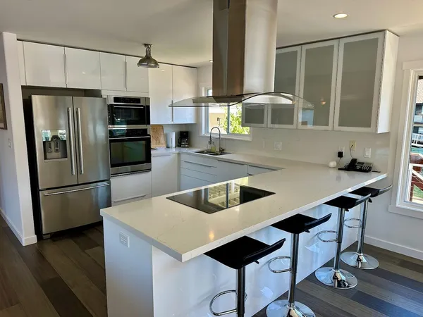 a kitchen with kitchen island a counter and a refrigerator