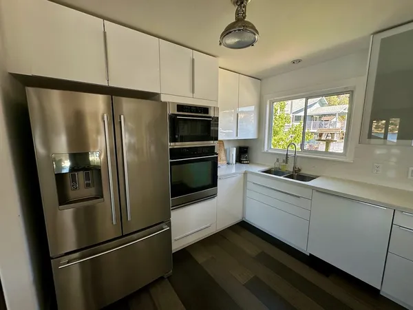 a kitchen with stainless steel appliances a refrigerator and a sink