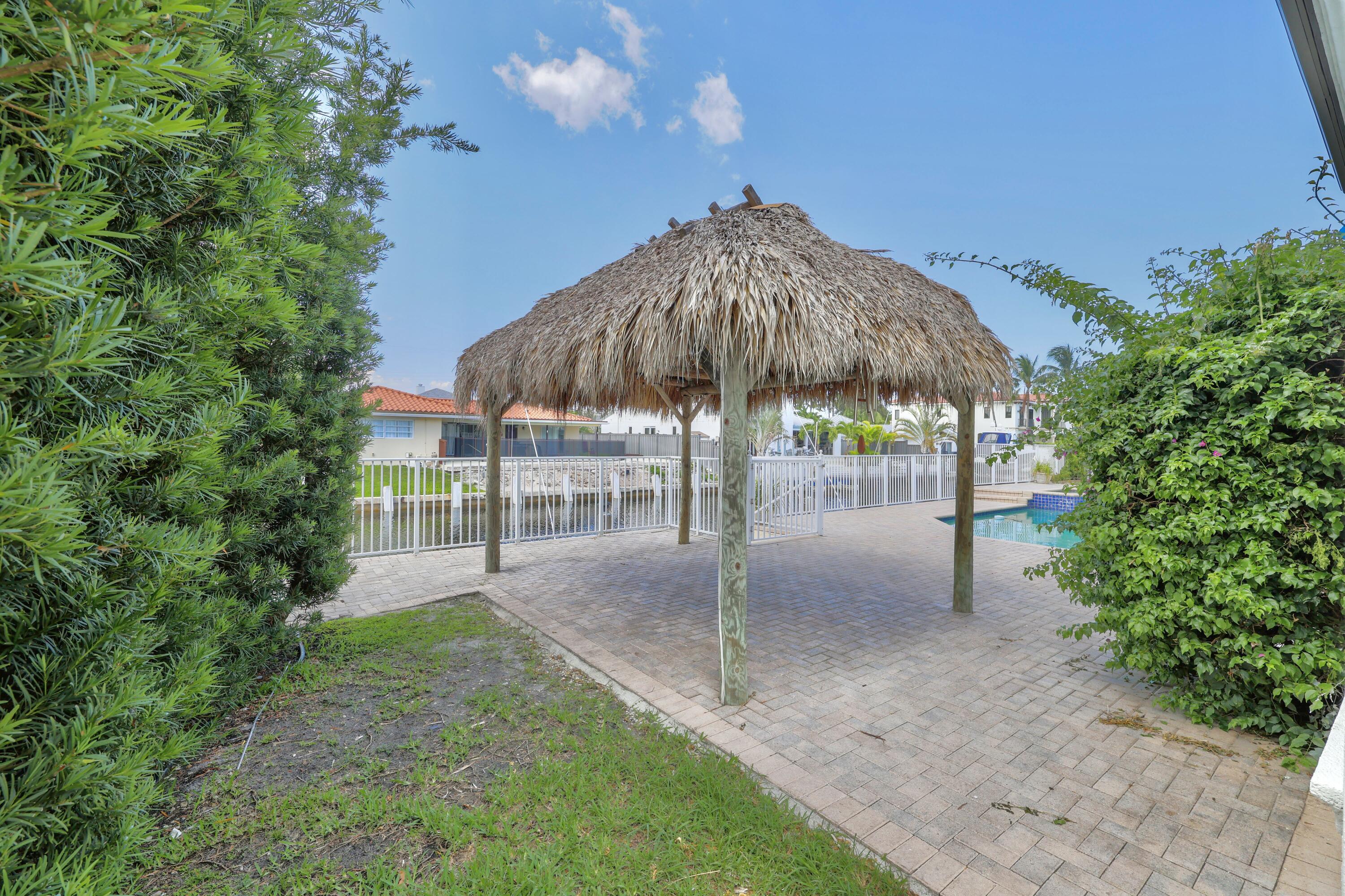 749 Northeast 71st Street Boca Raton, FL 33487 - Photo 41 of 43 a view of a backyard with a garden and patio