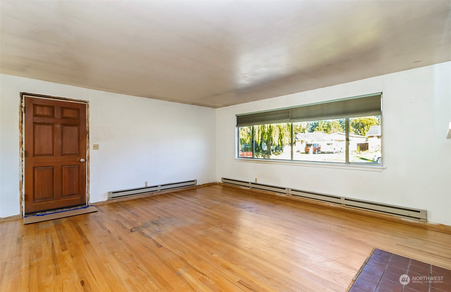 2416 6th Street Everett, WA 98201 - Photo 11 of 36 an empty room with wooden floor and windows