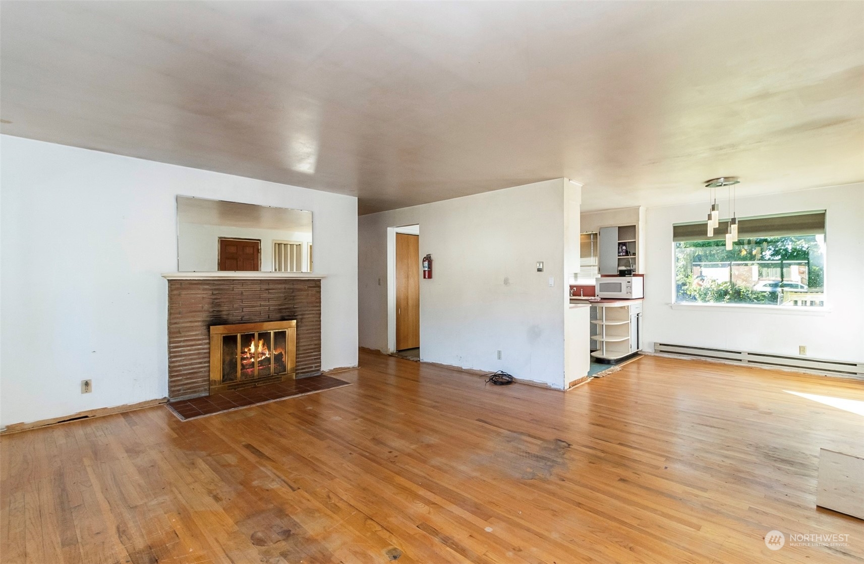 2416 6th Street Everett, WA 98201 - Photo 13 of 36 an empty room with wooden floor and a fireplace