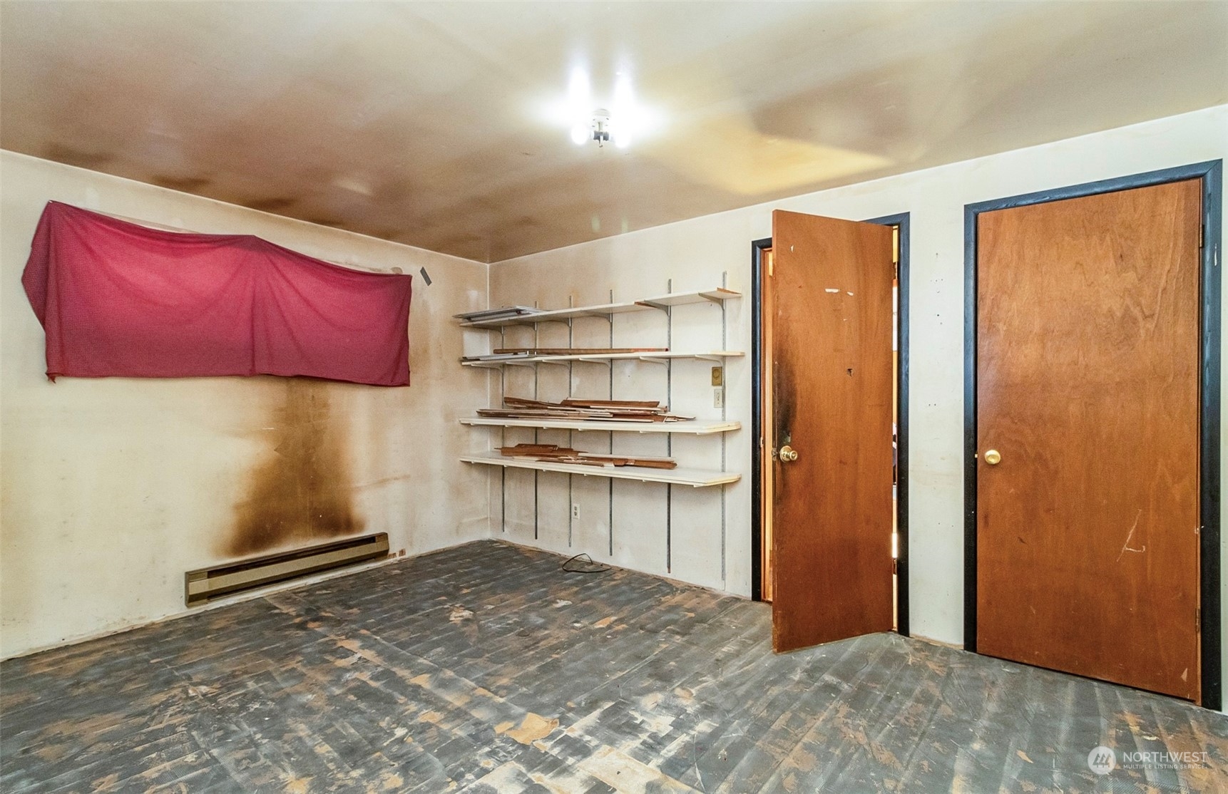 2416 6th Street Everett, WA 98201 - Photo 18 of 36 a room with a refrigerator and cabinets
