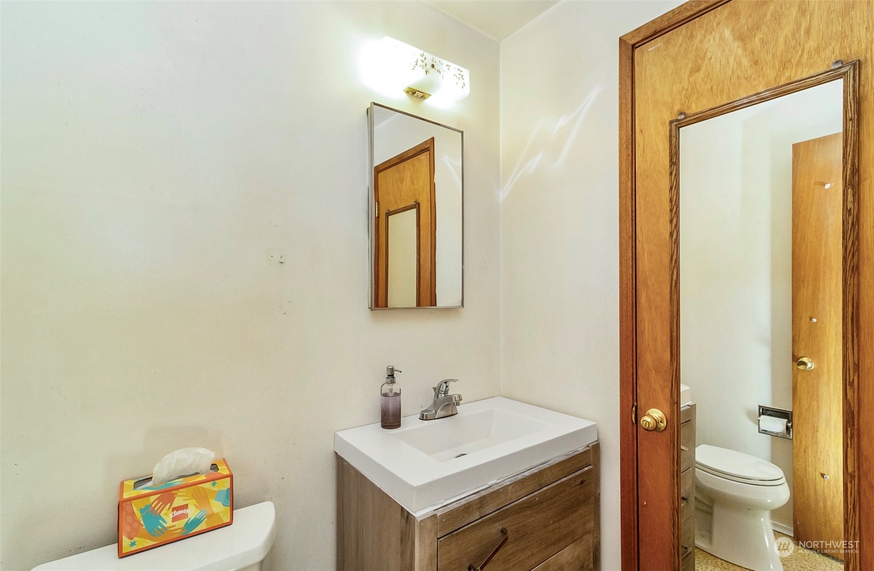 2416 6th Street Everett, WA 98201 - Photo 23 of 36 a bathroom with a toilet sink vanity and mirror