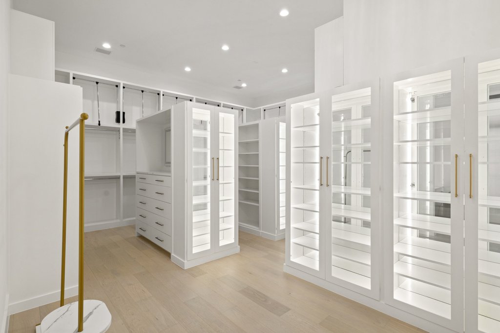 7117 Davenport Divide Road Austin, TX 78738 - Photo 24 of 40 Custom cabinetry and ample shelving define this thoughtfully designed walk-in closet.
