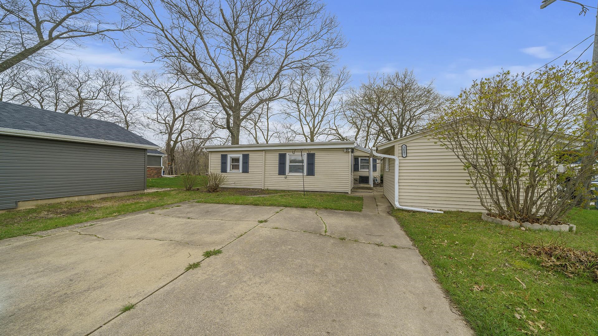 2687 South Snyder Road Oregon, IL 61061 - Photo 25 of 33 a view of a yard in front of a house with a large tree