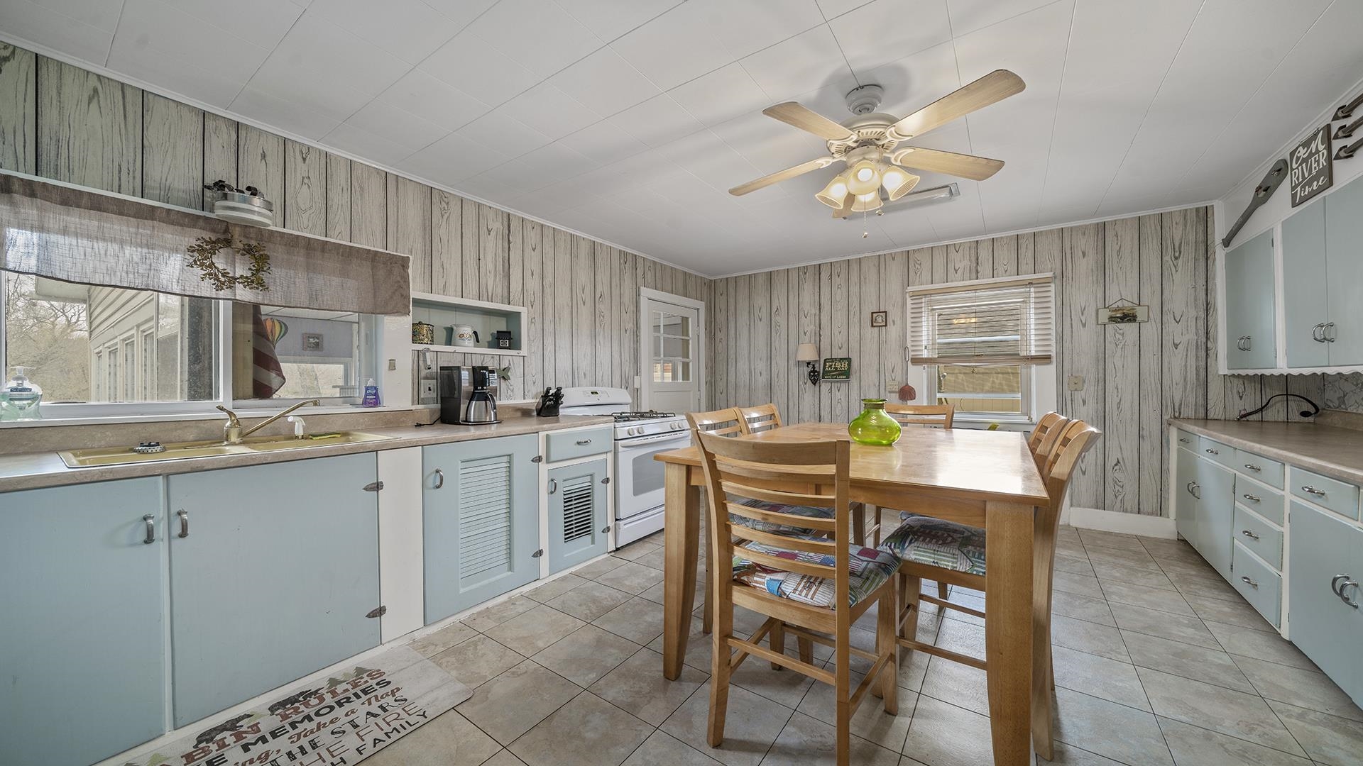 2687 South Snyder Road Oregon, IL 61061 - Photo 9 of 33 a kitchen with a dining table chairs cabinets and stainless steel appliances
