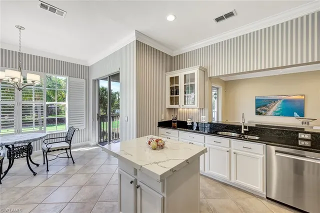 a dining room with furniture a chandelier and a rug