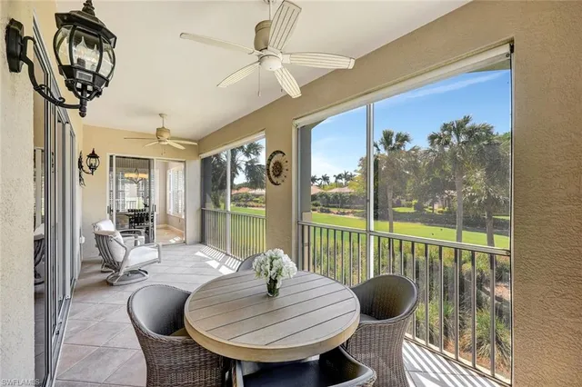 a kitchen with a sink a counter top space and living room view