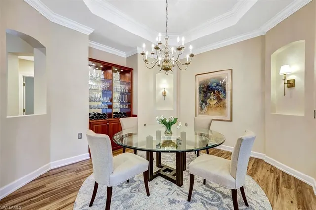 a kitchen with a sink a refrigerator and cabinets