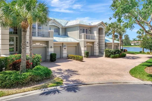 a front view of a residential houses with yard and green space