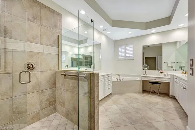 a large white bathroom with a sink double vanity and a bathtub