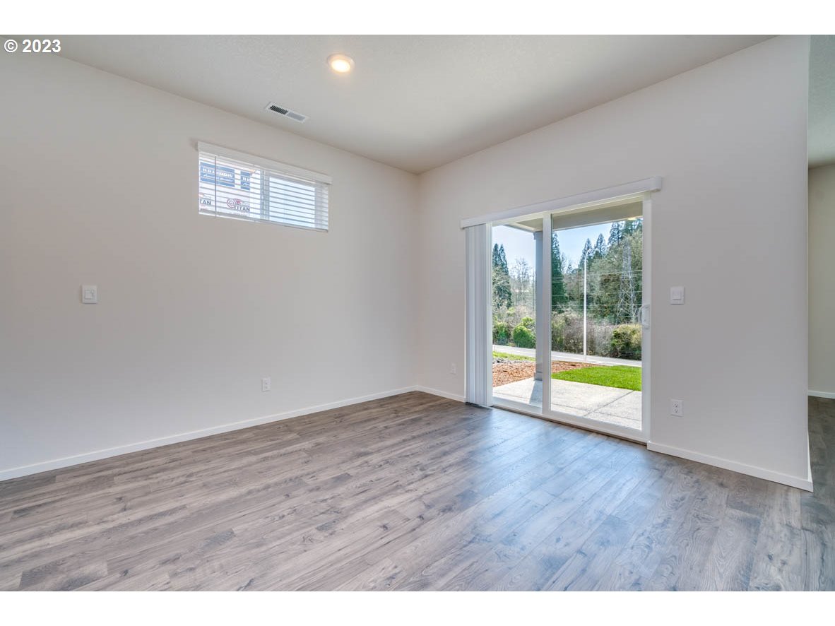 3492 Southeast Olvera Avenue Gresham, OR 97080 - Photo 15 of 23 a view of an empty room with wooden floor and a window
