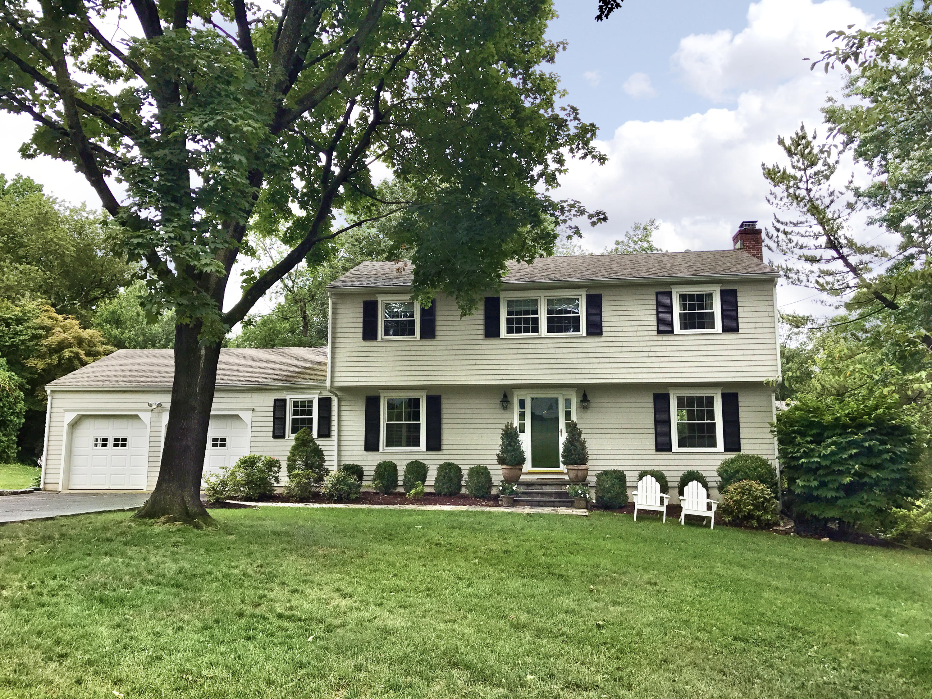 15 Wilson Ridge Road Darien, CT 06820 - Photo 1 of 42 a front view of a house with a garden