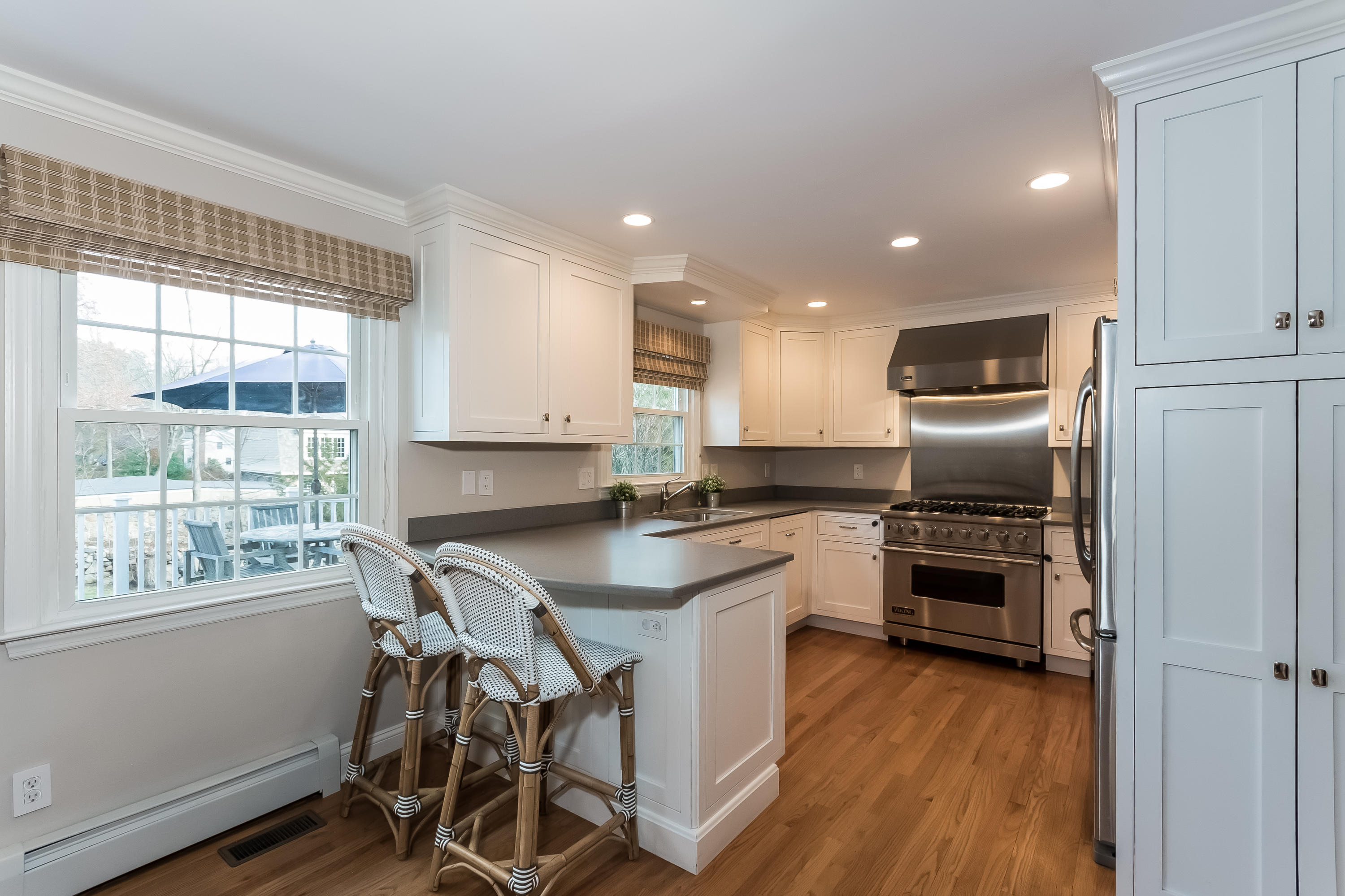 15 Wilson Ridge Road Darien, CT 06820 - Photo 14 of 42 a kitchen with kitchen island a stove a sink a refrigerator and wooden floor