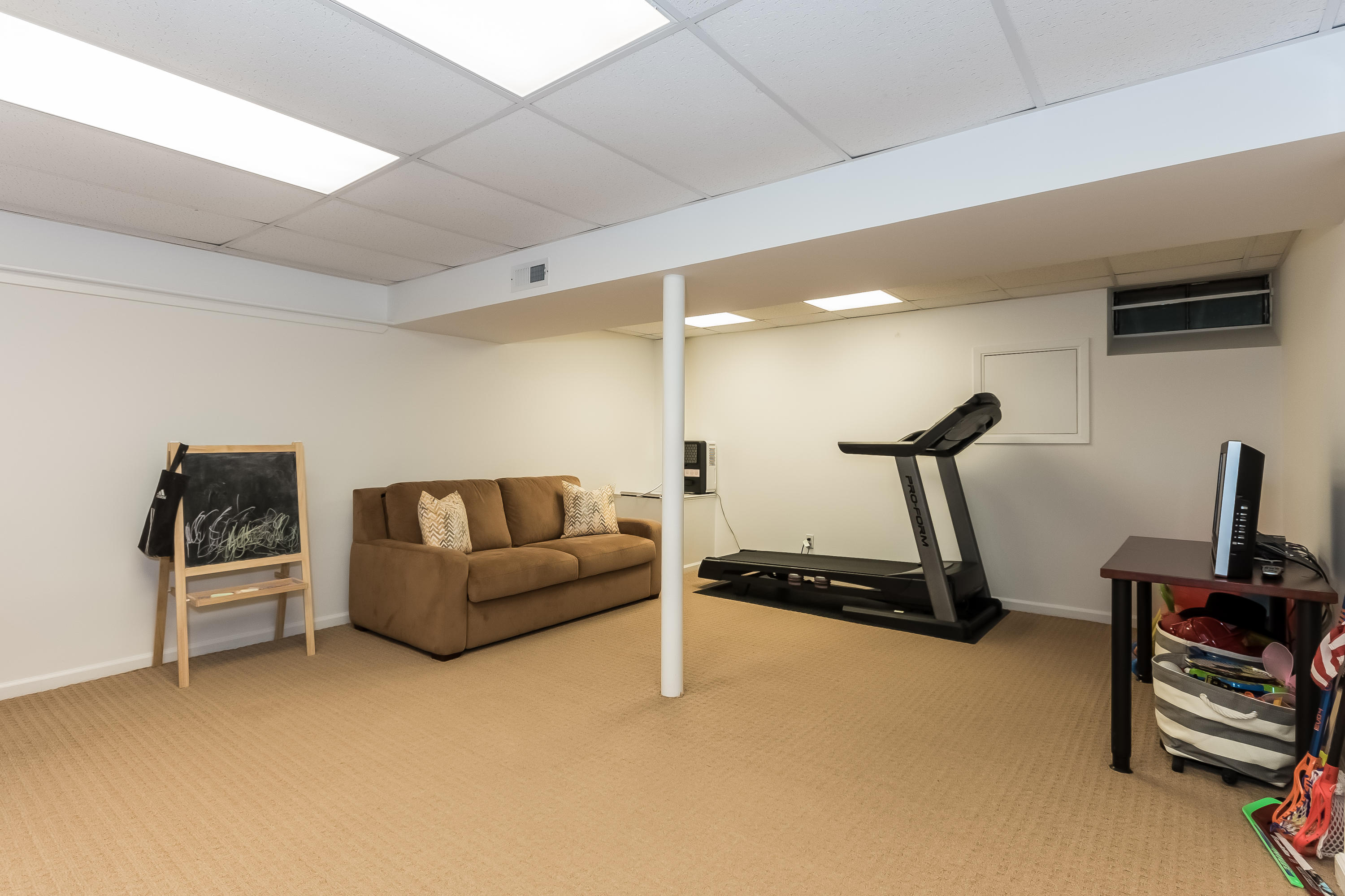 15 Wilson Ridge Road Darien, CT 06820 - Photo 33 of 42 a living room with furniture gym equipment and a flat screen tv