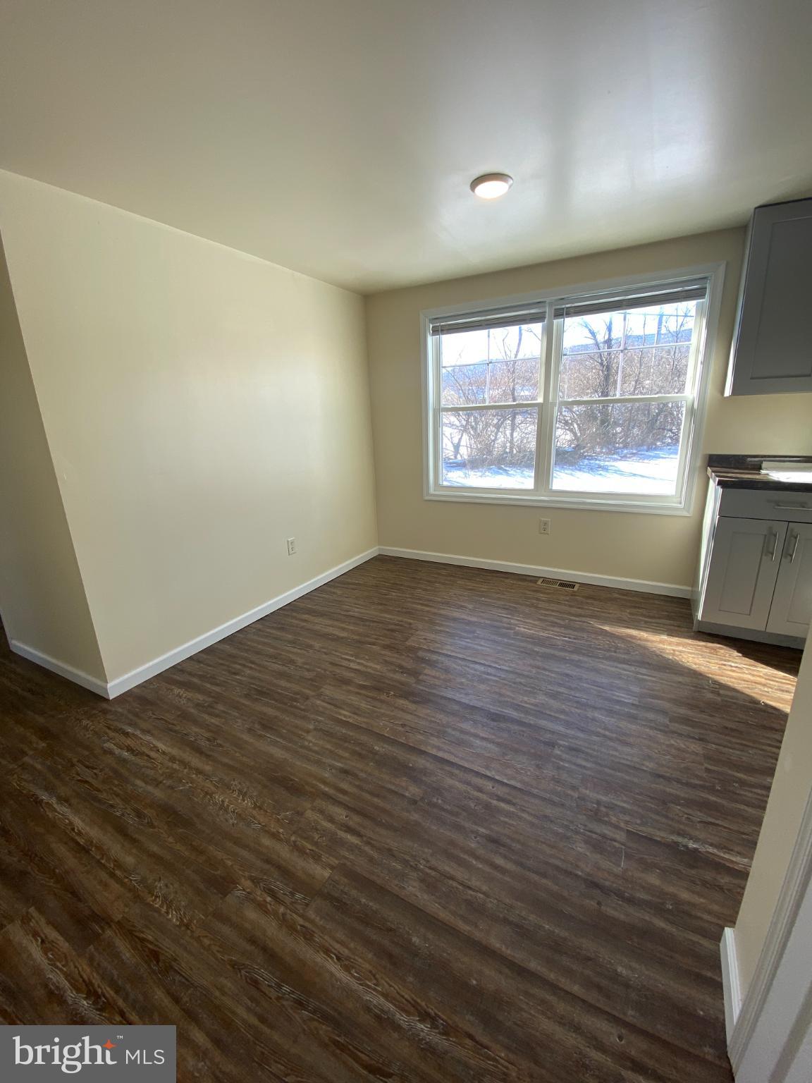 71 Boddy Lane Keyser, WV 26726 - Photo 7 of 17 an empty room with wooden floor and windows