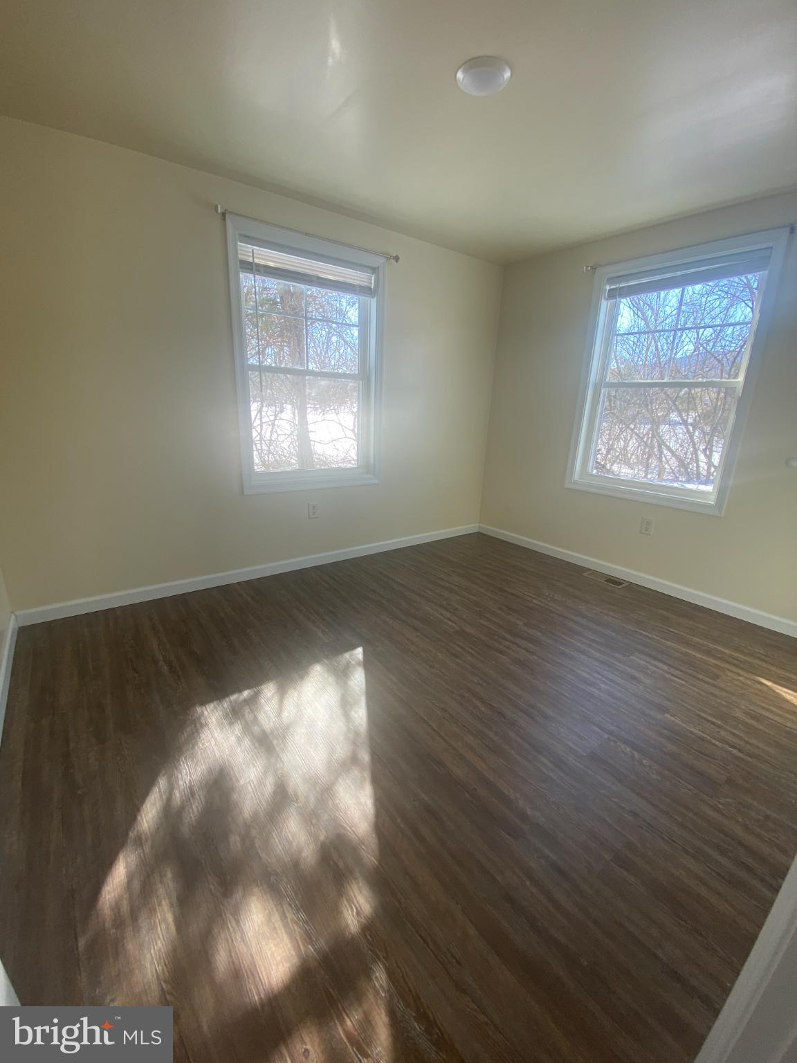 71 Boddy Lane Keyser, WV 26726 - Photo 9 of 17 an empty room with wooden floor and windows