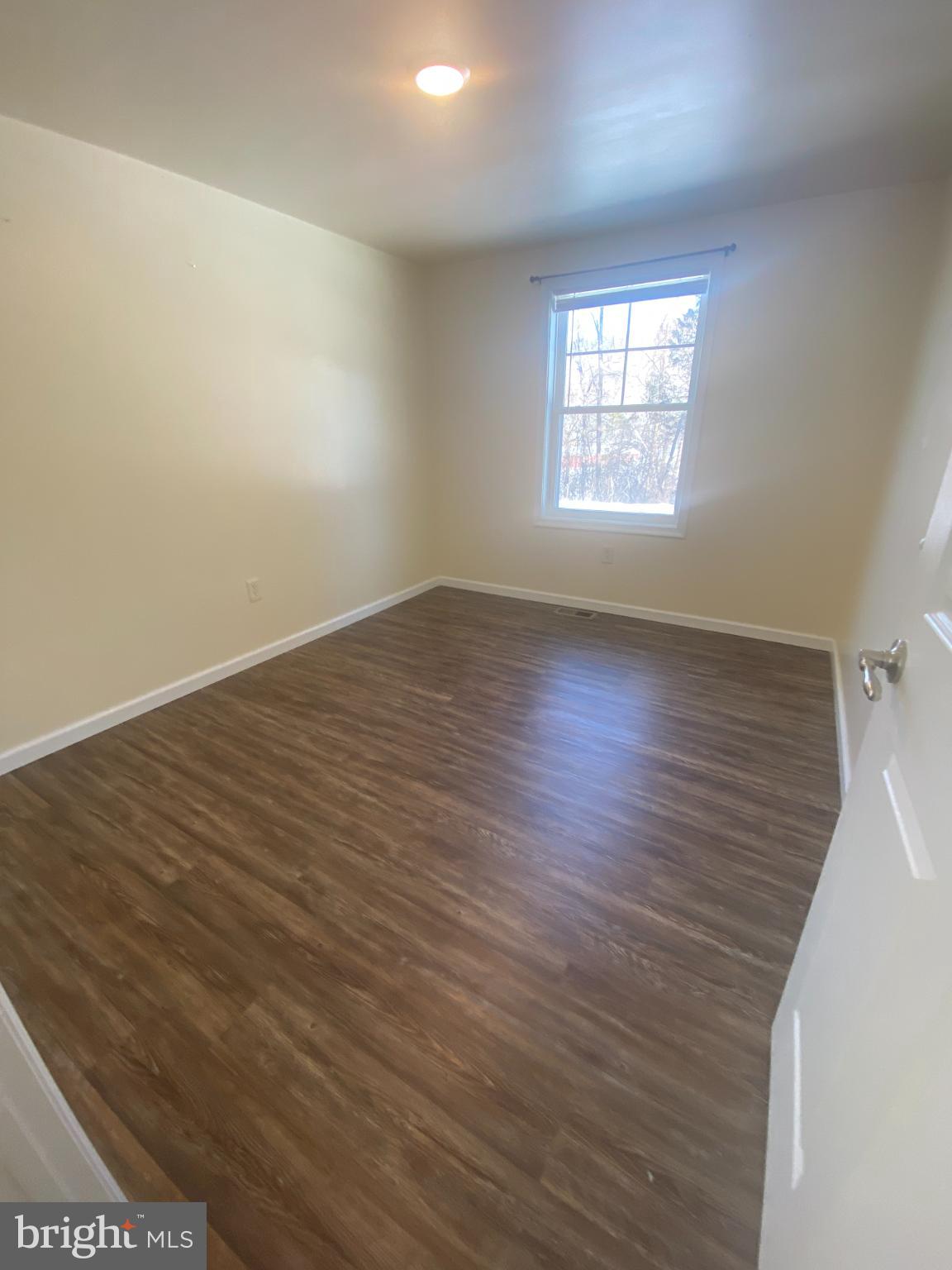 71 Boddy Lane Keyser, WV 26726 - Photo 10 of 17 an empty room with wooden floor and windows