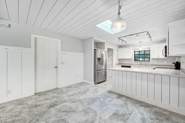 a view of a kitchen with a sink and cabinets