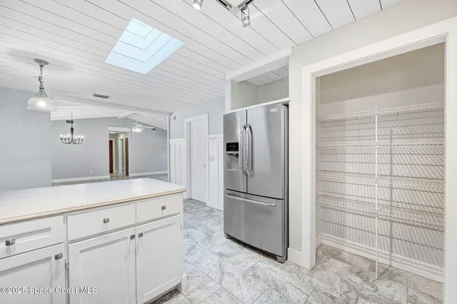 a kitchen with a refrigerator and cabinets